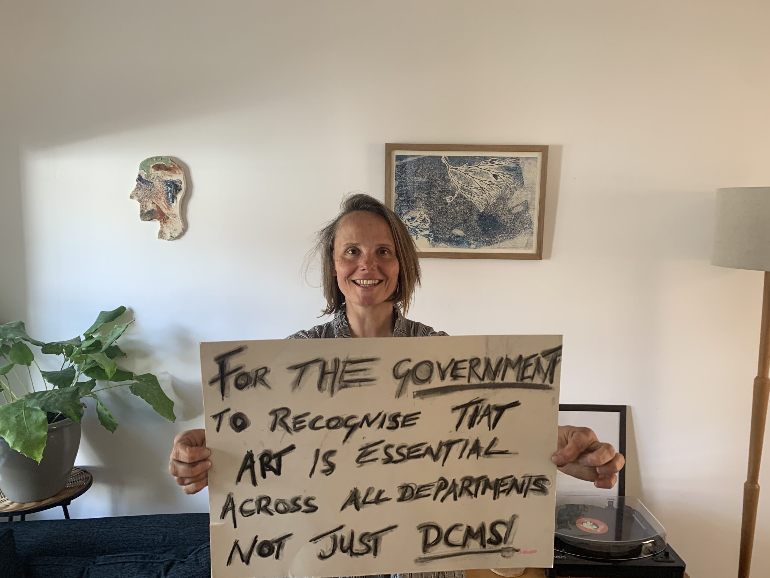 Person holding sign to protest for the arts